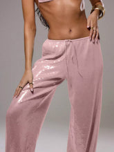 Pink sequin wide leg pants with drawstring waist featuring sparkling sequin wide design and relaxed fit wide leg pants