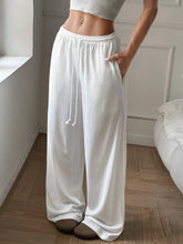 White relaxed wide leg sweatpants with elastic waistband drawstring in loose-fitting comfortable design