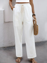 White perfee drawstring wide straight pants featuring high waist, drawstring closure, and two front pockets