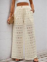 Cream-colored wide leg pants featuring decorative button wide closure and lace detailing with a high waist design