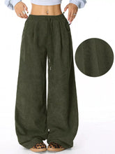 Olive green relaxed fit corduroy pants with wide legs and a drawstring waistband in soft corduroy fabric