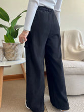 Black corduroy high-waisted wide leg pants with side pockets machine wash and tumble dry safe