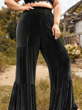 Plus size velvet ruffle hem wide leg pants in black velvet with side pockets and ruffled hem detail