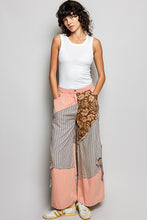 Patchwork wide-leg pants in soft pink with brown floral and striped panels featuring a side big star patch and partial elastic