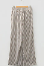 Beige and black vertically striped wide-leg trousers with elastic high waist and pockets for comfortable wear