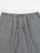 Striped wide leg drawstring pants in black and white with a comfortable drawstring waistband for casual wear