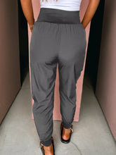 High waist pocketed dark gray jogger pants with elastic high waist, stretchy fabric, relaxed fit, and cuffed ankles