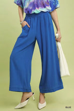 Bright blue umgee linen elastic waist wide leg pants with relaxed, flowing fabric and comfortable elastic waistband