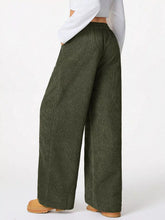 Olive green relaxed fit corduroy pants with wide legs and drawstring waist for comfortable casual wear