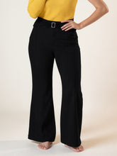 Plus size high-waisted flare pants in black with a silver rectangular buckle belt for a stylish fit
