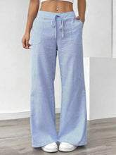 Light blue and white striped wide leg pants with a drawstring waistband in a comfortable wide leg design
