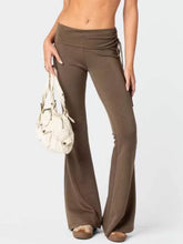 Brown high-waisted flare pants in polyester fabric featuring a drawstring waistband for adjustable fit