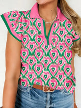 A vibrant pink and green abstract heart short sleeve blouse with striped trim polo collar and contrasting solid pink collar