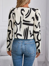 Cream and black abstract print blouse with puff sleeves