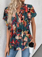Teal abstract print blouse with ruffled short sleeves and a v-neckline perfect for casual or office wear