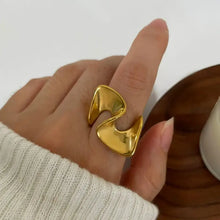 Shiny 18K gold-plated abstract wave ring on finger