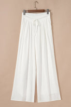White flowy wide leg pants with elastic waist and matching drawstring for comfortable casual wear