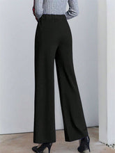 Black high-waisted wide leg pants made of smooth tailored fabric for a polished and stylish look