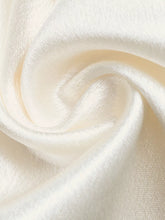 Cream-colored satin wide-leg pants with lace waist detailing and a smooth glossy texture and subtle sheen