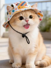 White pet bucket hat with chin strap, hearts and cartoon animals