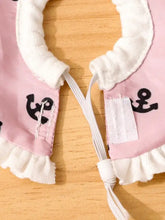 Pink soft pet collar with white ruffles, black anchor, elastic ties