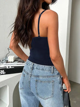 Navy blue scoop neck bodysuit with adjustable thin straps and fitted silhouette in soft fabric