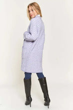 Woman modeling Adora Chevron Cardigan long-sleeve light purple sweater with black boots