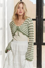 Woman in Adora long sleeves crochet knit sweater in green and white stripes
