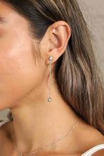 Woman’s ear with adored moissanite chain earrings in sterling silver