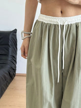 Olive green wide leg drawstring casual pants with white elastic waistband and matching drawstring for comfort