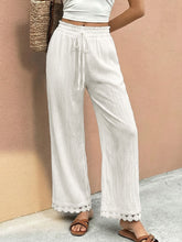 White wide leg trousers with a drawstring waist and delicate lace trim hem lace trim wide leg pants