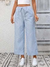 Light blue and white striped wide leg pants with a drawstring waistband perfect for casual wear
