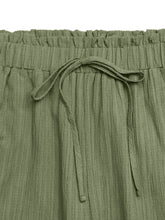 Olive green wide leg drawstring waist pants made of textured fabric with a comfortable drawstring waistband