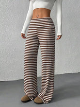 Brown and white striped wide leg pants with ribbed waistband made from soft fabric for comfortable wear