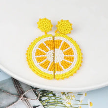 Pair of yellow and white beaded orange shape earrings in alloy