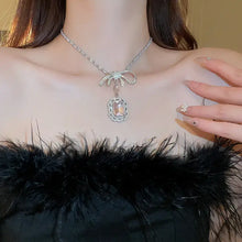 Silver alloy crystal geometric pendant necklace with bow and pink gemstone