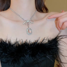 Silver alloy crystal geometric pendant necklace with bow and pink gemstone