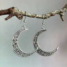 Silver alloy cutout moon earrings with filigree crescent design