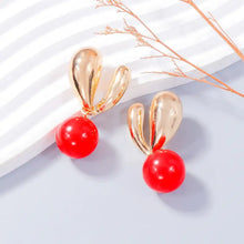 Alloy drip oil bunny earrings with red beads and gold wavy elements