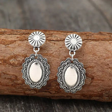 Ornate alloy flower dangle earrings with oval silver pendants