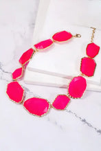 Hot pink alloy frame resin necklace with gold accents and faceted stones