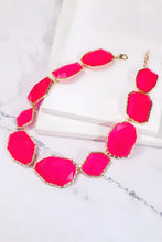 Hot pink alloy frame resin necklace with gold accents and faceted stones