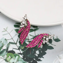Ornate magenta alloy glass stone stud earrings with clear crystals