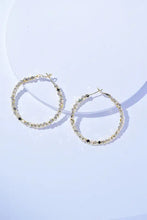 Gold-toned alloy hoop earrings with faceted beads