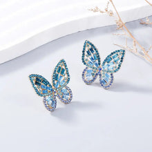 Two blue and teal inlaid rhinestone butterfly earrings in alloy