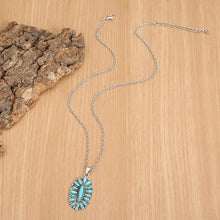 Silver-tone alloy necklace with oval artificial turquoise cluster pendant