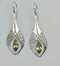 Ornate alloy rhinestone cutout earrings with peridot gemstones