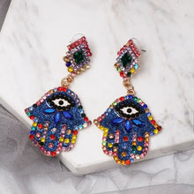 Blue Hamsa hand rhinestone earrings with evil eye design