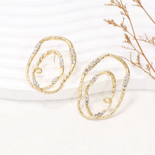Gold-toned rhinestone geometric earrings with abstract swirls