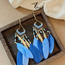 Gold-toned alloy rice bead dangle earrings with blue feathers